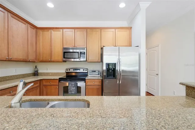 a kitchen with a refrigerator sink and microwave