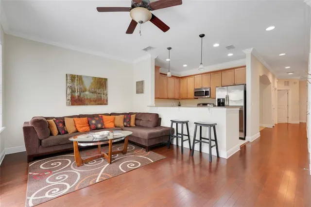 a living room with kitchen island furniture and a kitchen view