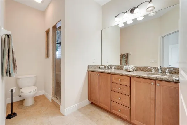 a bathroom with a double vanity sink and a toilet