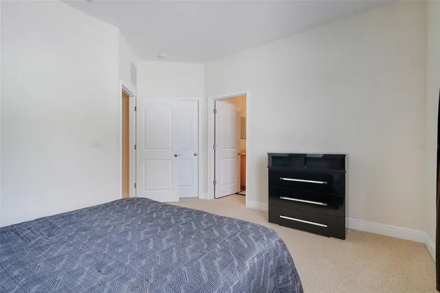 a bedroom with a bed and a dresser