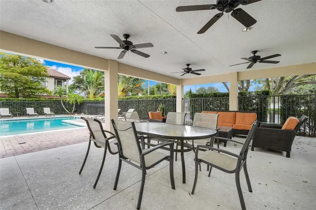 a dining room with furniture and a floor to ceiling window