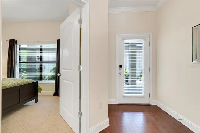 a view of a room with a window and wooden floor