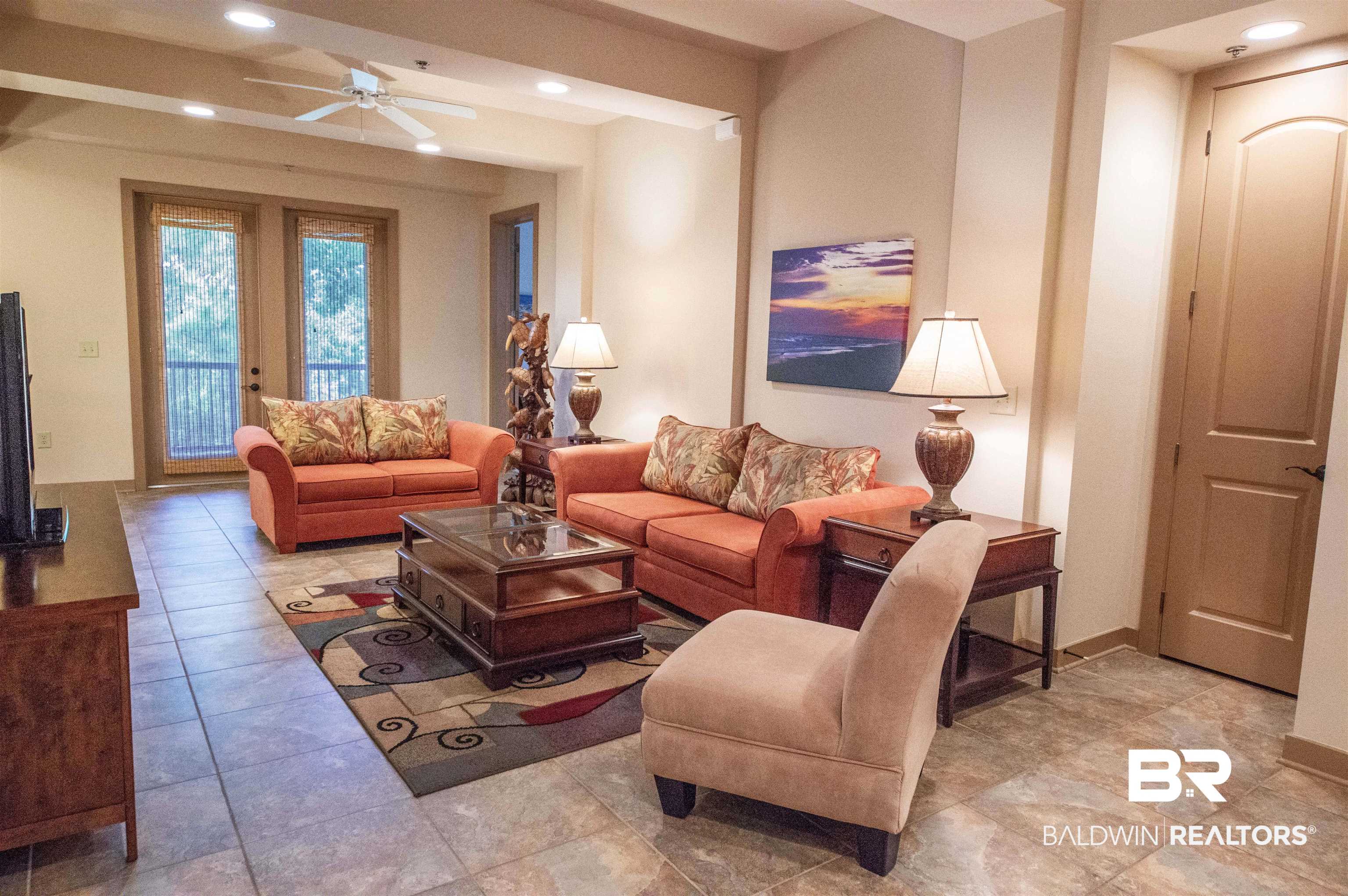 1430 Regency Road, Unit 301C Gulf Shores, AL 36542 - Photo 19 of 22 Tiled living room featuring ceiling fan