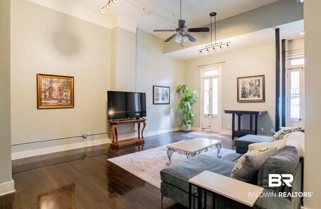 204 Conti Street, Unit 1C Mobile, AL 36602 - Photo 8 of 12 Living room featuring rail lighting, wood-type flooring, and a ceiling fan