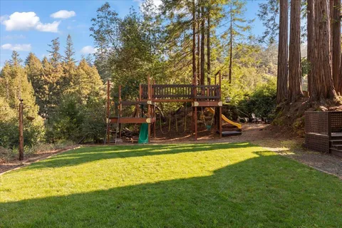 a view of a swimming pool with a patio and a yard