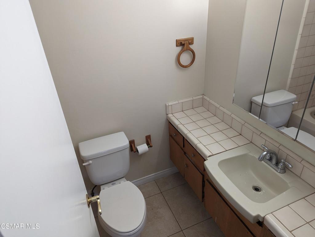 2441 Pierce Court Simi Valley, CA 93065 - Photo 4 of 11 a bathroom with a sink toilet and mirror