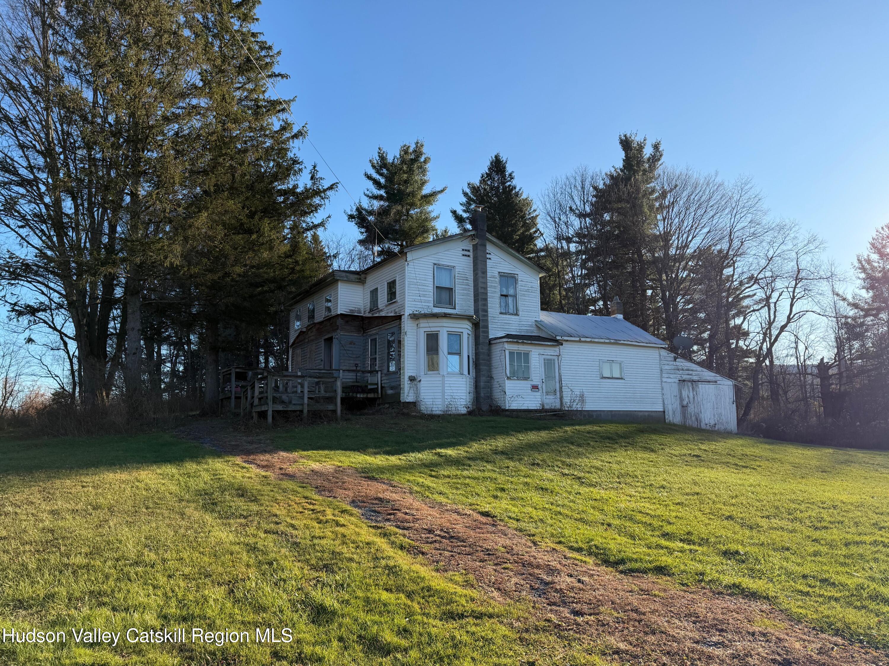 2075 Switzkill Road Berne, NY 12023 - Photo 2 of 7 a view of a big house with a big yard and a large tree