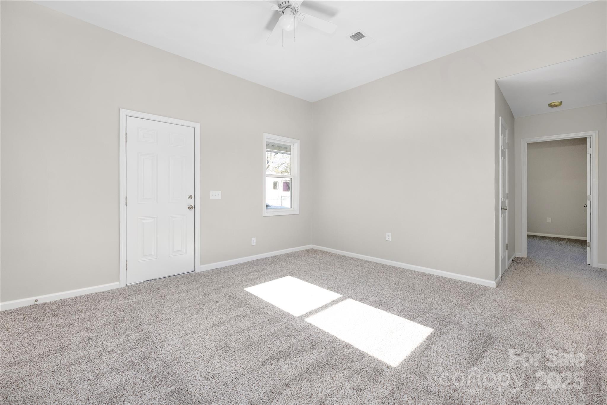 528 6th Street Chester, SC 29706 - Photo 13 of 31 an empty room with a chandelier fan and windows