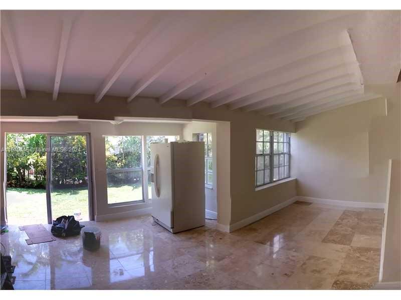 2424 Southwest 21st Street Miami, FL 33145 - Photo 5 of 9 a view of an empty room with wooden floor and a floor to ceiling window