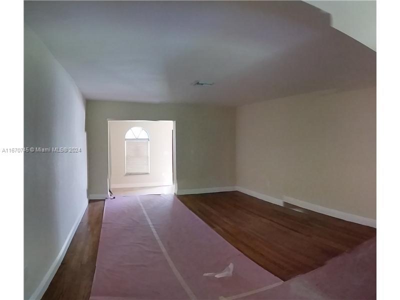 2424 Southwest 21st Street Miami, FL 33145 - Photo 6 of 9 an empty room with wooden floor and windows
