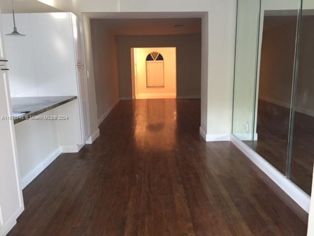 2424 Southwest 21st Street Miami, FL 33145 - Photo 7 of 9 a hallway with wooden floor closet and front door