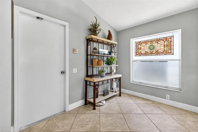 a dining room with furniture potted plants and wooden floor