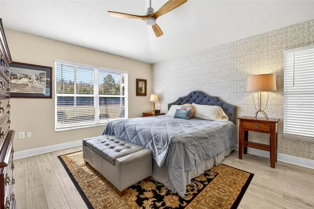 a bathroom with a granite countertop toilet sink and mirror