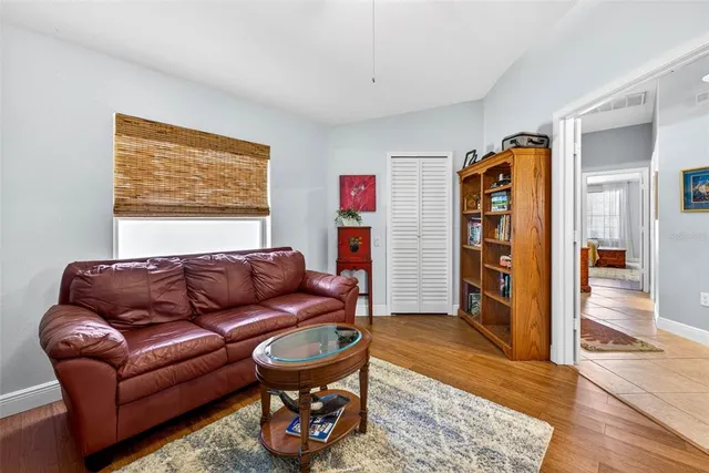 a bedroom with furniture and a large window