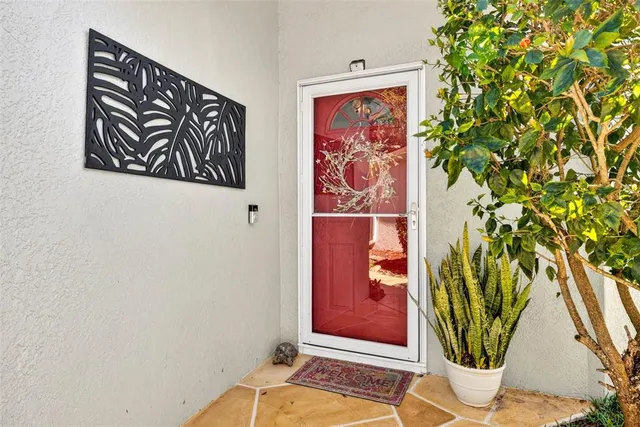 a view of a hallway with wooden floor and furniture