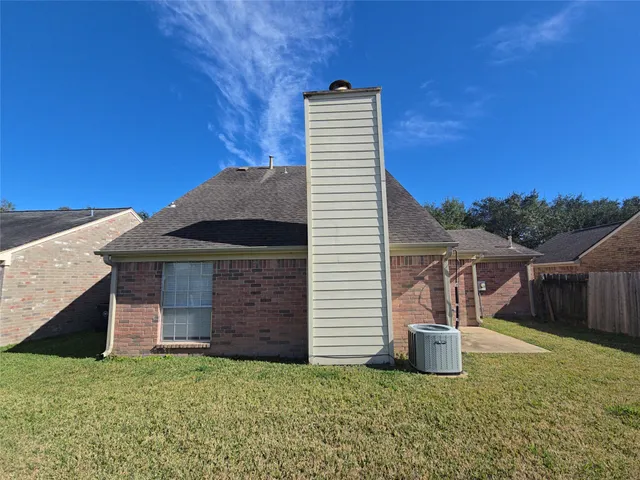 a view of a small house with backyard
