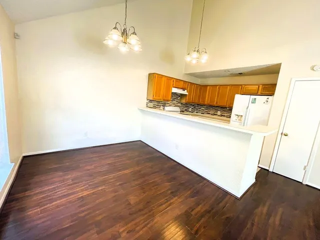 a view of a kitchen with wooden floor