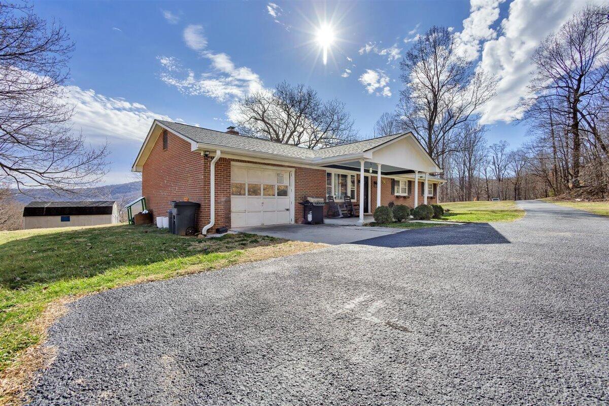 4889 Bore Auger Road Blue Ridge, VA 24064 - Photo 3 of 41 a front view of a house with a yard and garage