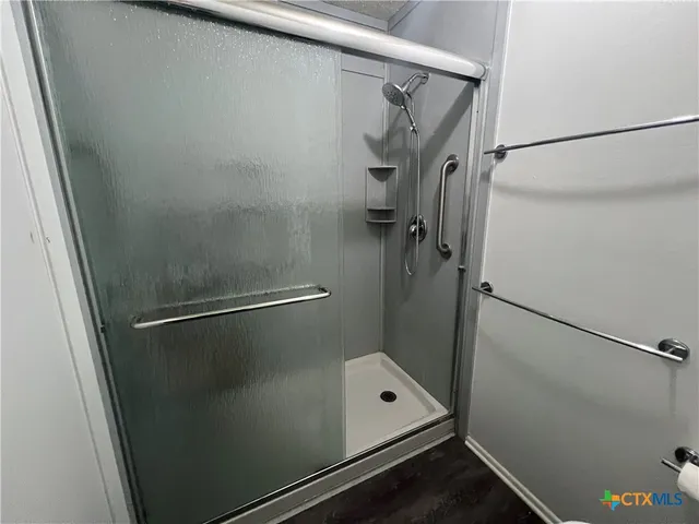 a bathroom with a glass shower door