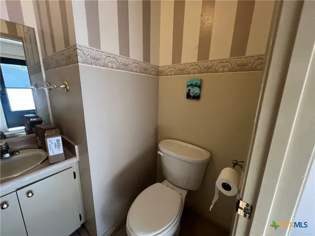 a white toilet sitting next to a sink