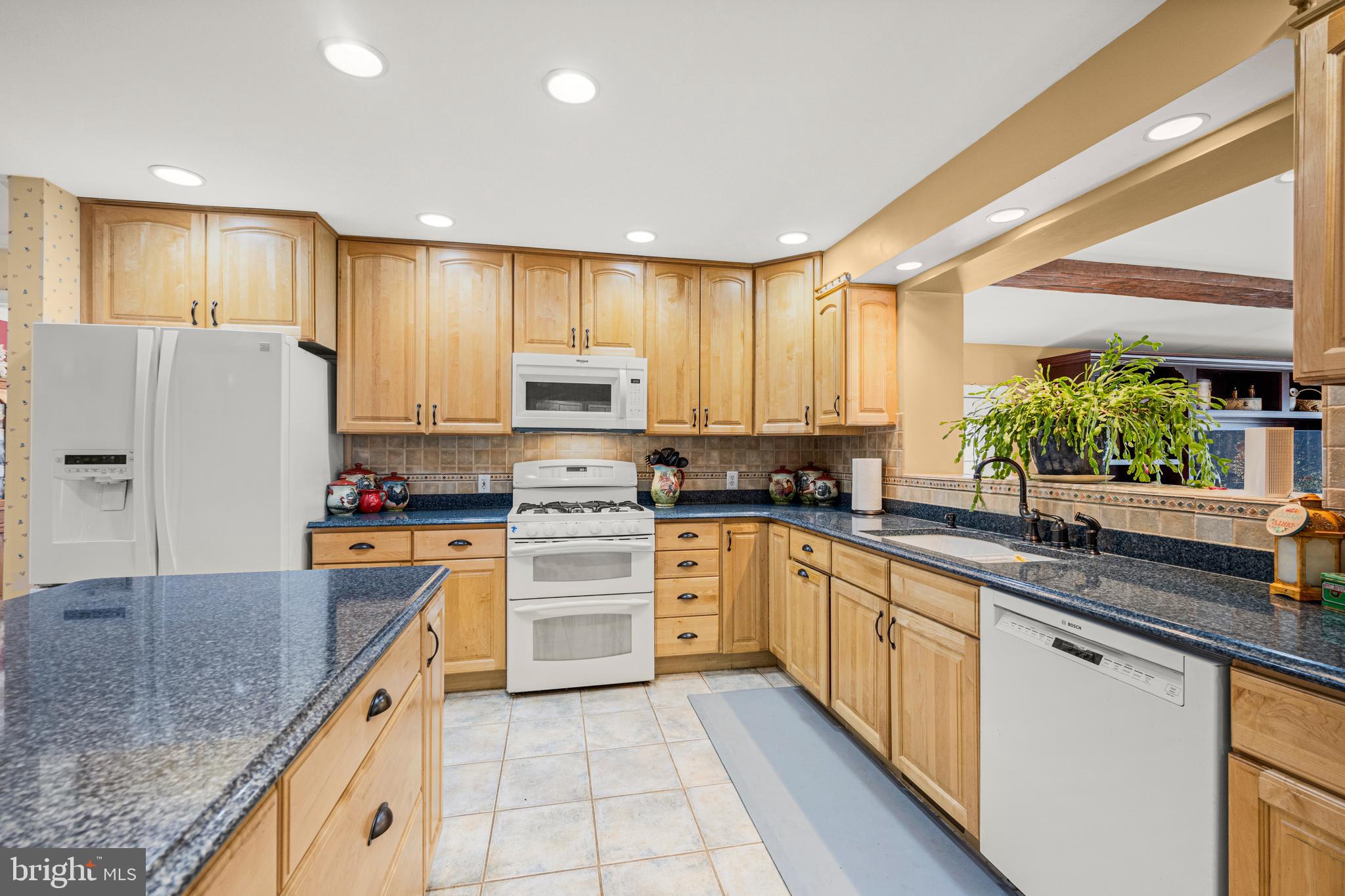 7491 Mink Hollow Road Highland, MD 20777 - Photo 15 of 67 a kitchen with stainless steel appliances granite countertop a refrigerator sink stove microwave and cabinets