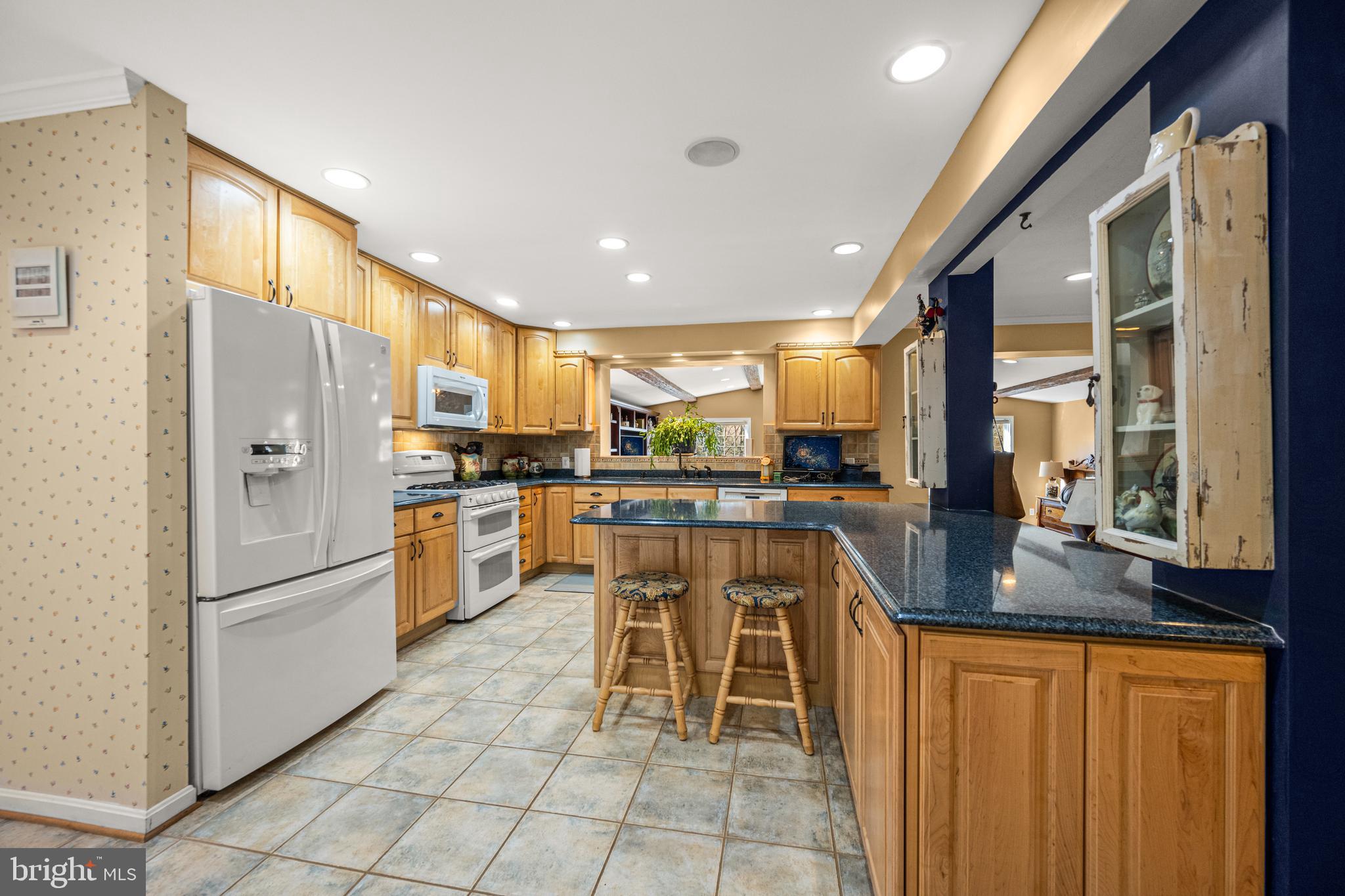 7491 Mink Hollow Road Highland, MD 20777 - Photo 16 of 67 a kitchen with appliances cabinets and chair