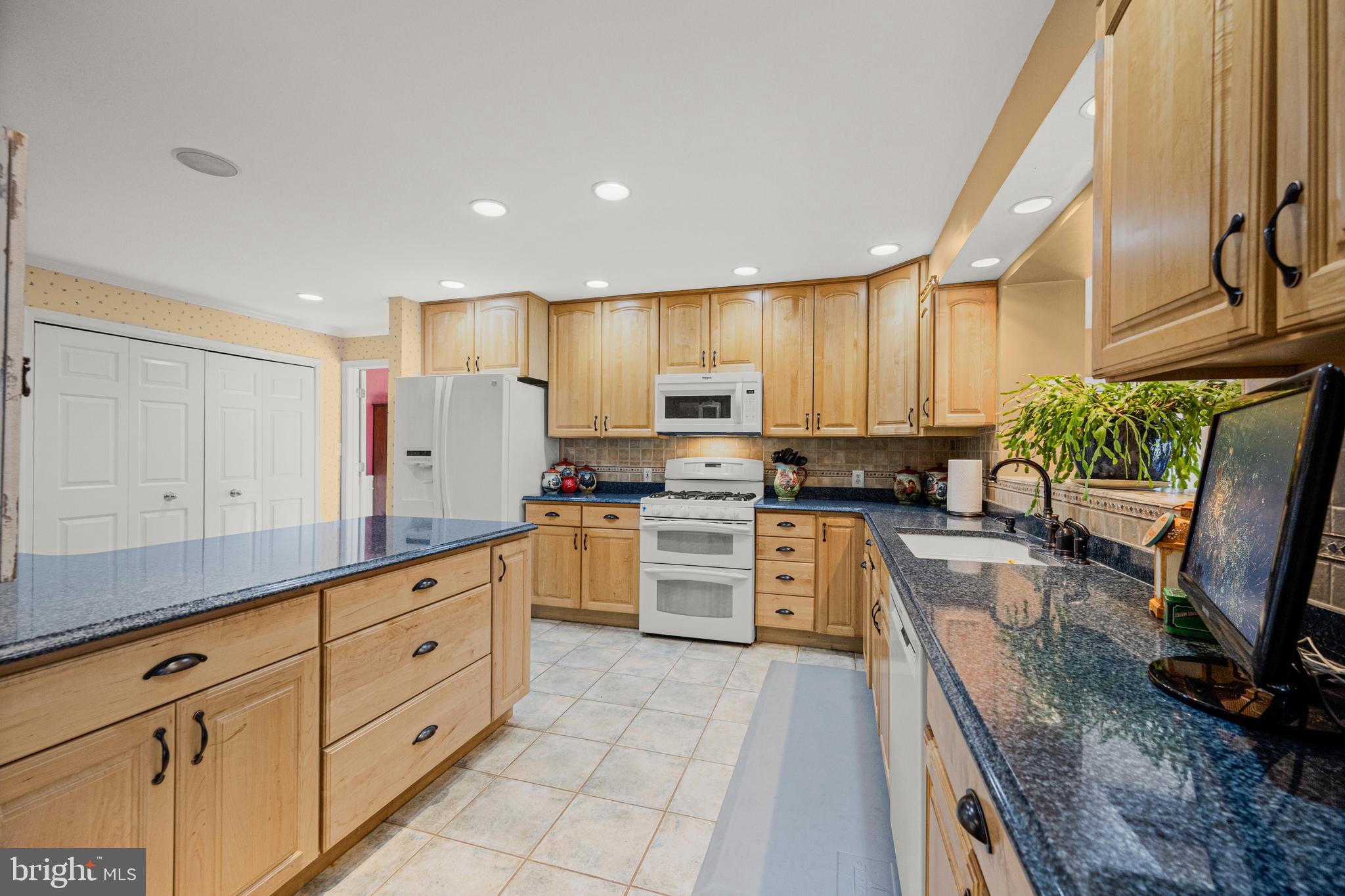 7491 Mink Hollow Road Highland, MD 20777 - Photo 18 of 67 a kitchen with granite countertop a sink stainless steel appliances and cabinets