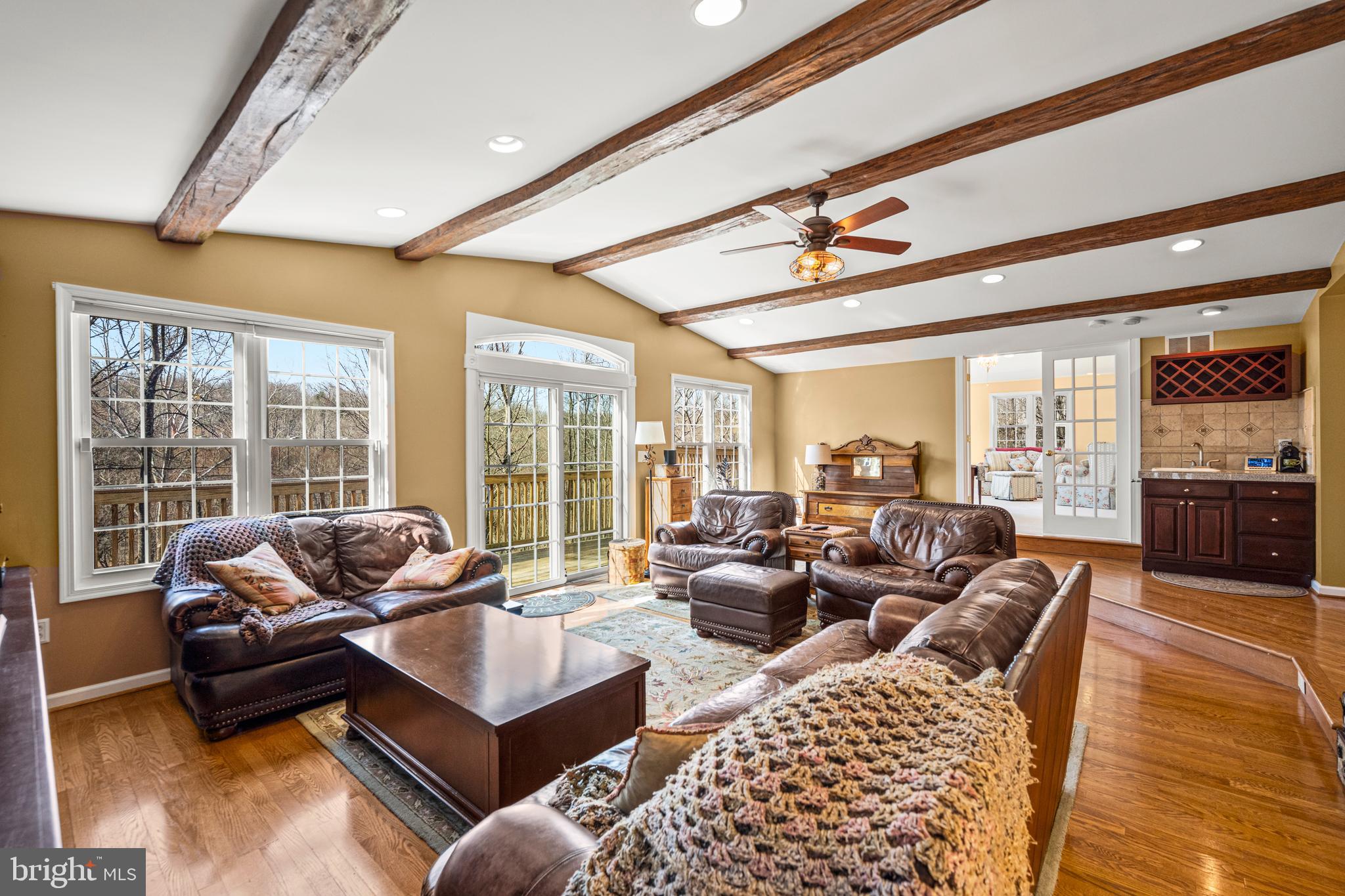 7491 Mink Hollow Road Highland, MD 20777 - Photo 28 of 67 a living room with furniture ceiling fan and a rug