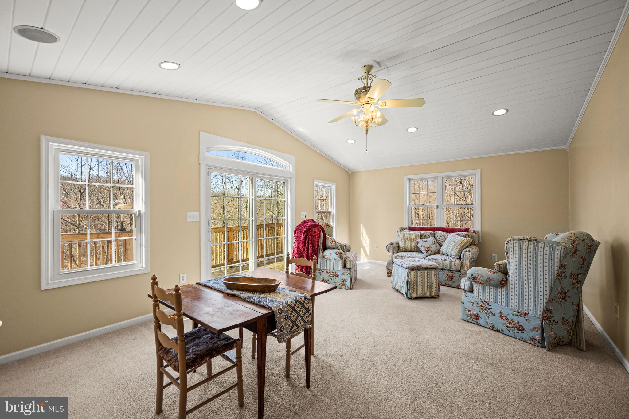 7491 Mink Hollow Road Highland, MD 20777 - Photo 32 of 67 a living room with furniture two window and a flat screen tv