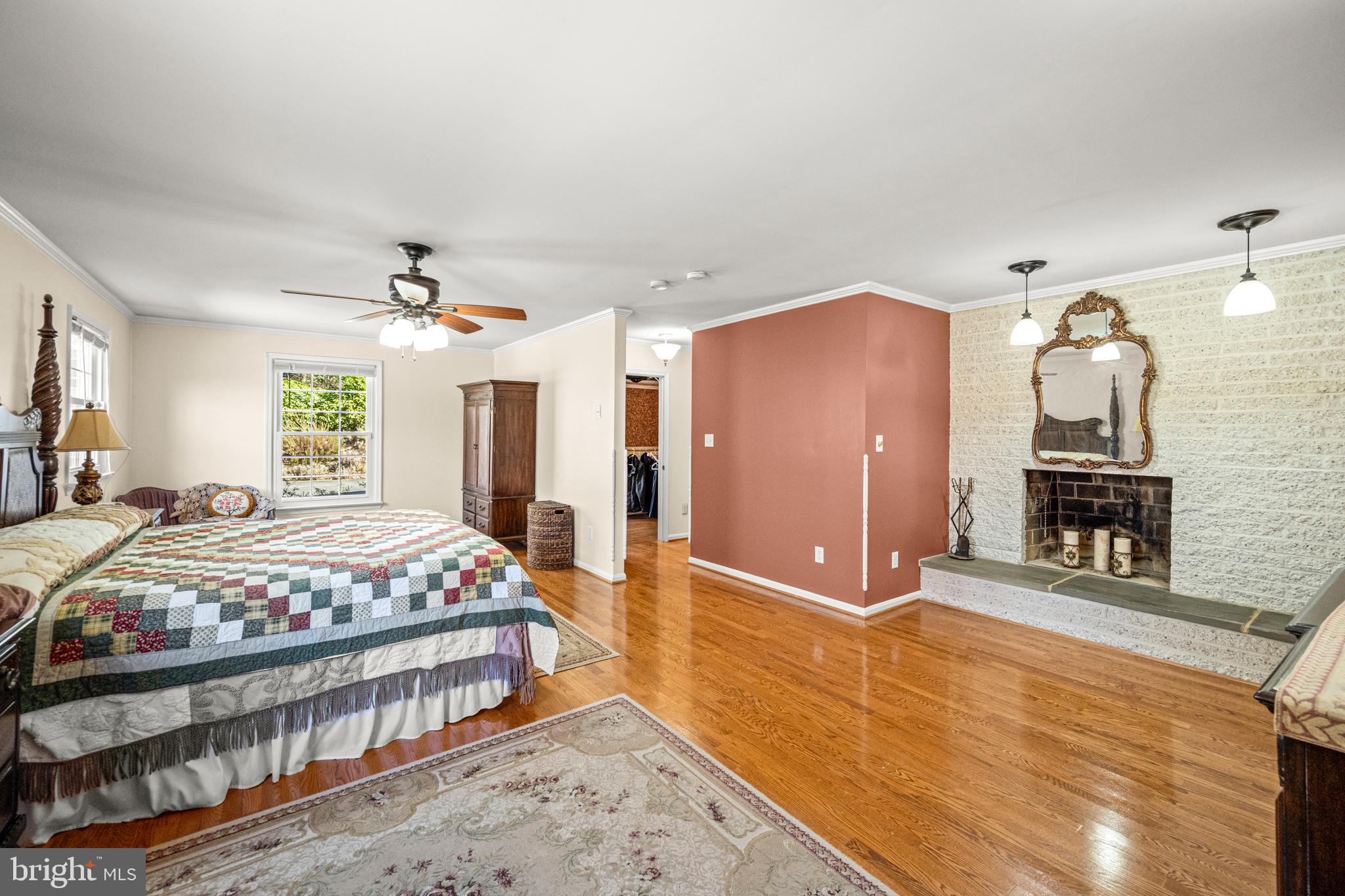 7491 Mink Hollow Road Highland, MD 20777 - Photo 36 of 67 a spacious bedroom with a bed a dresser and wooden floor