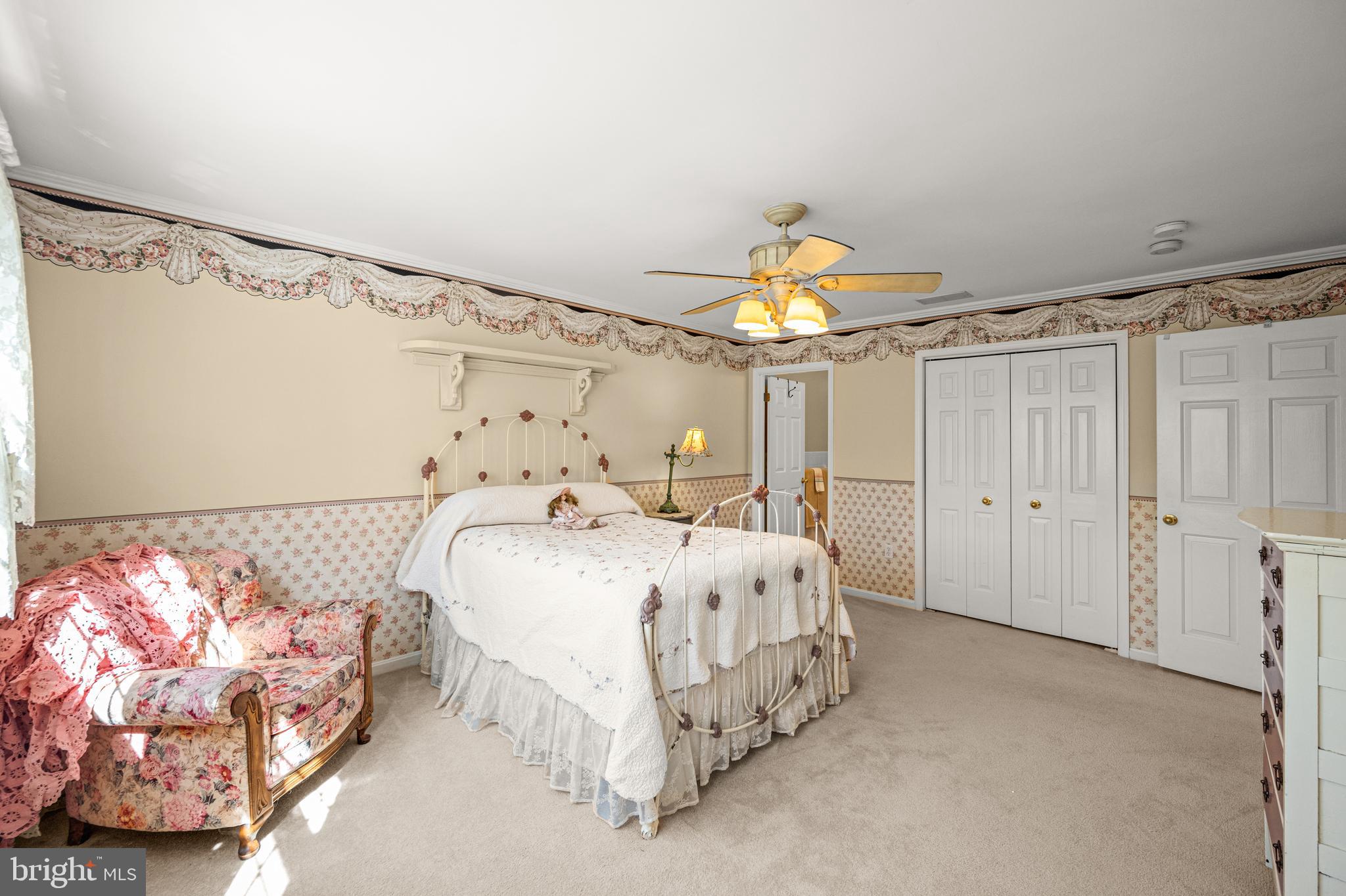7491 Mink Hollow Road Highland, MD 20777 - Photo 39 of 67 a bed room with a bed and a chandelier