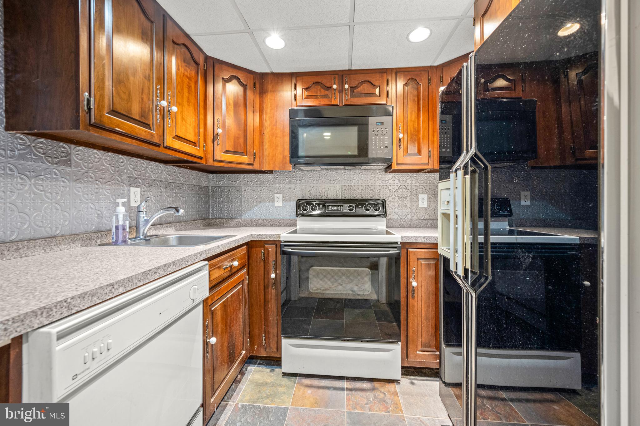 7491 Mink Hollow Road Highland, MD 20777 - Photo 46 of 67 a kitchen with stainless steel appliances granite countertop a stove microwave and sink