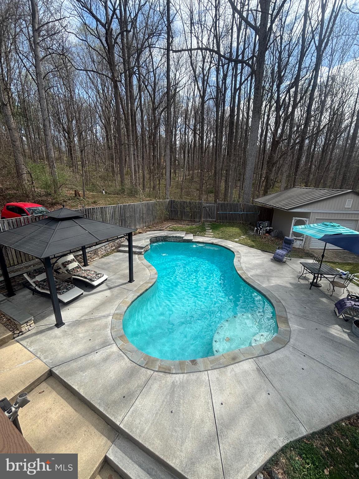 7491 Mink Hollow Road Highland, MD 20777 - Photo 57 of 67 a view of a swimming pool with sitting area