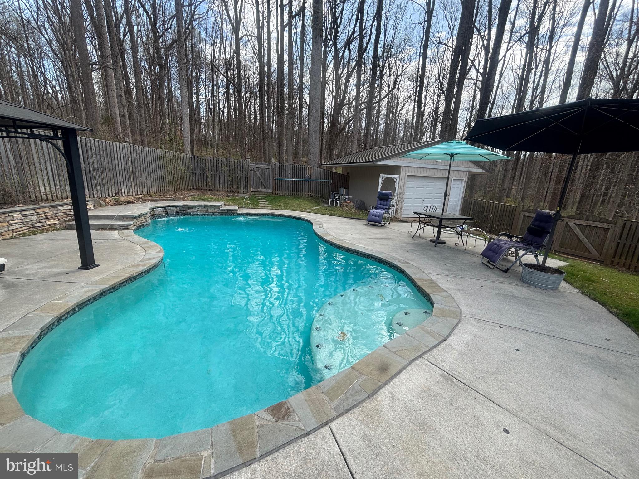 7491 Mink Hollow Road Highland, MD 20777 - Photo 58 of 67 a view of a swimming pool with a patio and a chairs