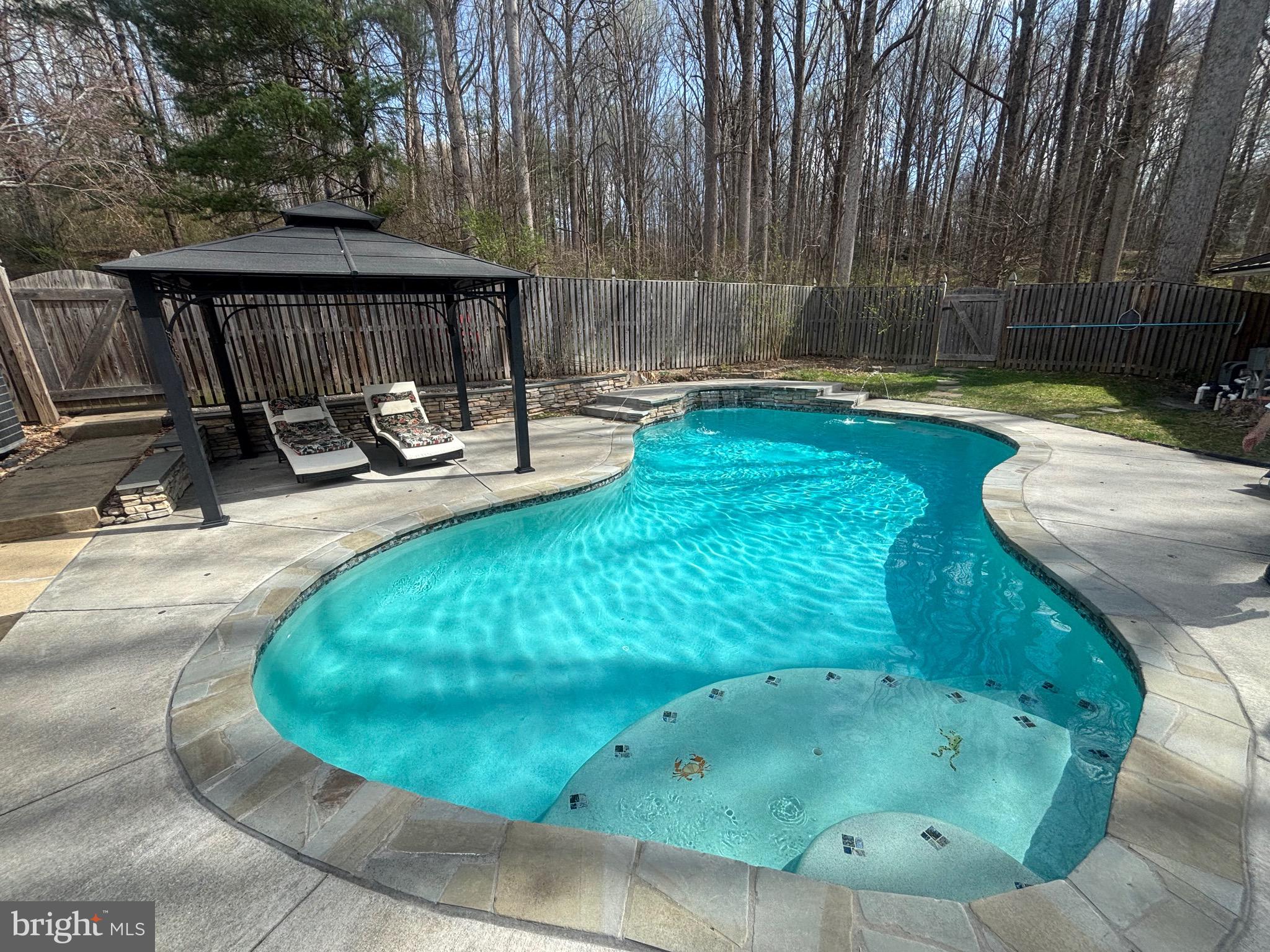 7491 Mink Hollow Road Highland, MD 20777 - Photo 62 of 67 a view of a swimming pool with a sitting space