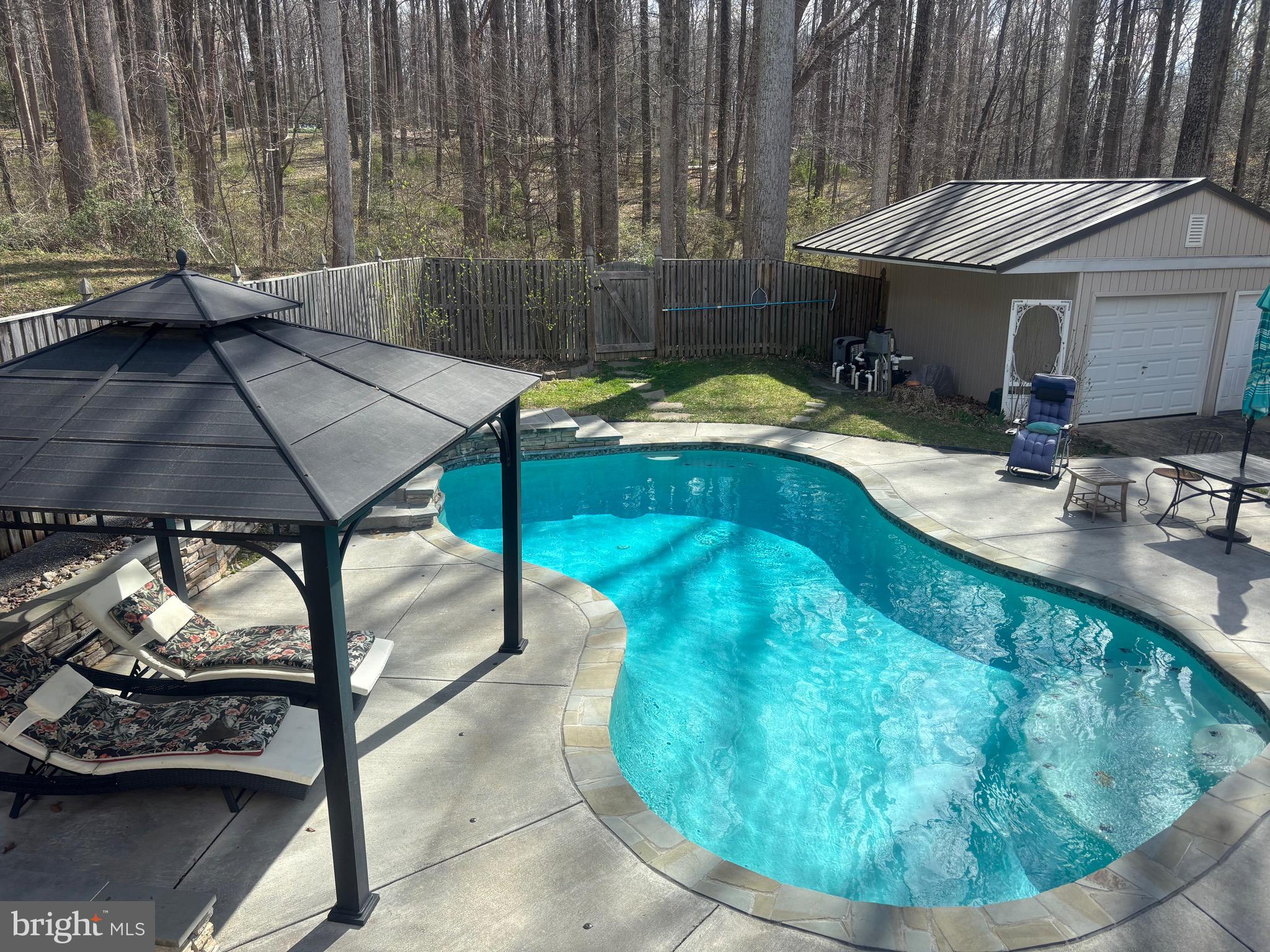 7491 Mink Hollow Road Highland, MD 20777 - Photo 7 of 67 a view of a swimming pool with a patio