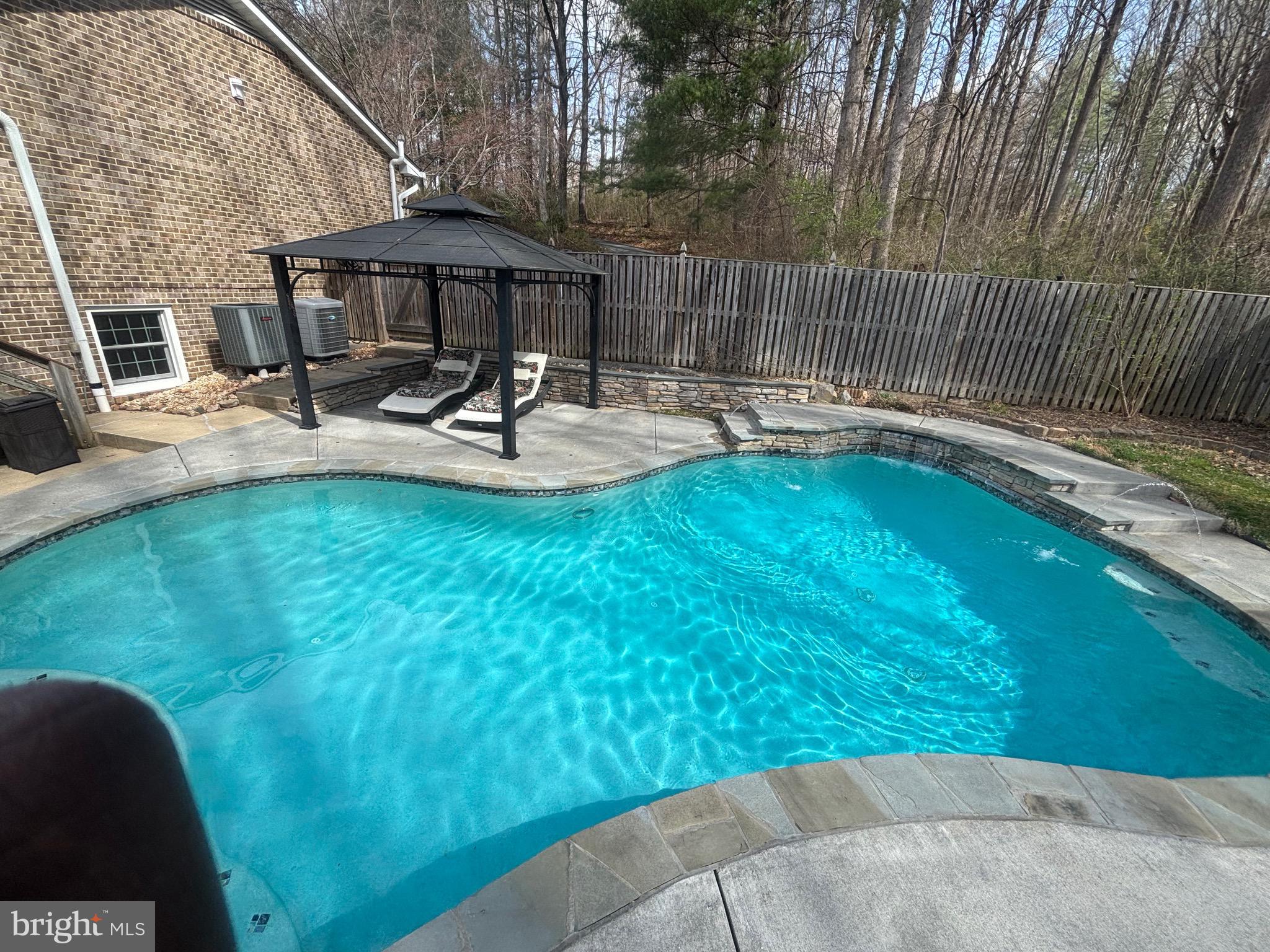 7491 Mink Hollow Road Highland, MD 20777 - Photo 9 of 67 a swimming pool with outdoor seating and yard