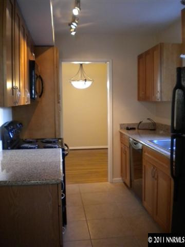 1720 Vale Street Reno, NV 89509 - Photo 2 of 13 a kitchen with a refrigerator and a stove top oven