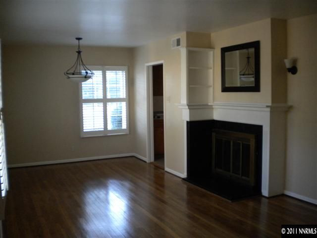 1720 Vale Street Reno, NV 89509 - Photo 3 of 13 a hallway with wooden floor fireplace and windows
