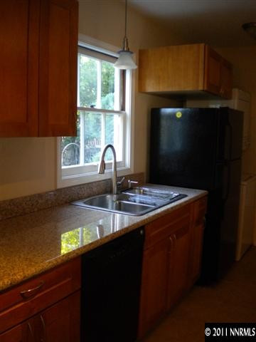 1720 Vale Street Reno, NV 89509 - Photo 7 of 13 a kitchen with a sink a window and cabinets