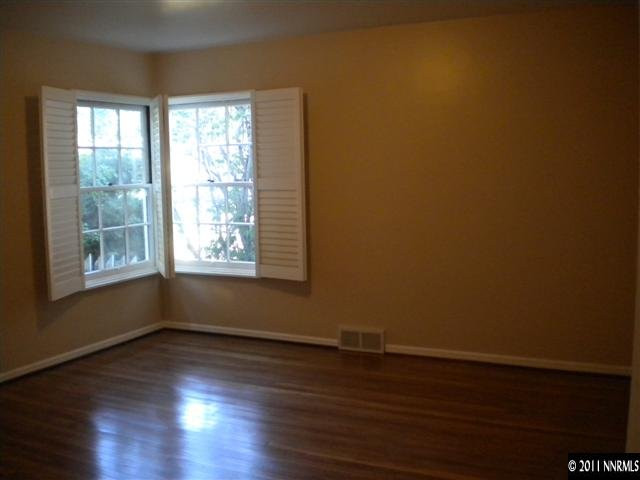1720 Vale Street Reno, NV 89509 - Photo 8 of 13 a view of an empty room with wooden floor and a window
