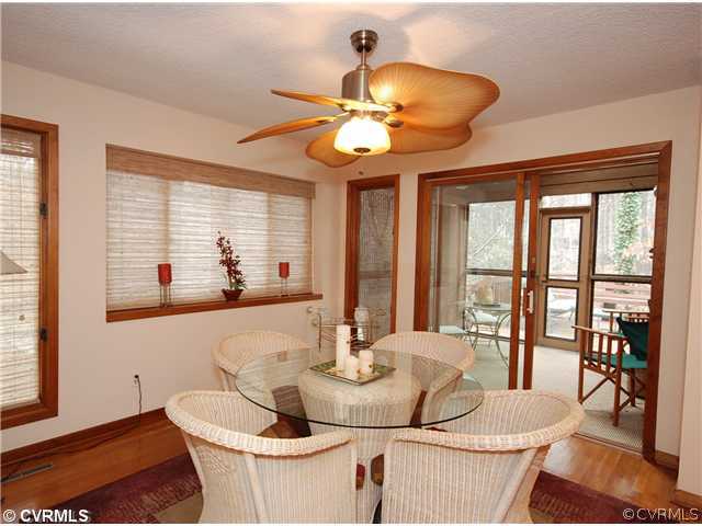 3303 Fortunes Ridge Road Midlothian, VA 23112 - Photo 5 of 12 a dining room with wooden floor and large windows
