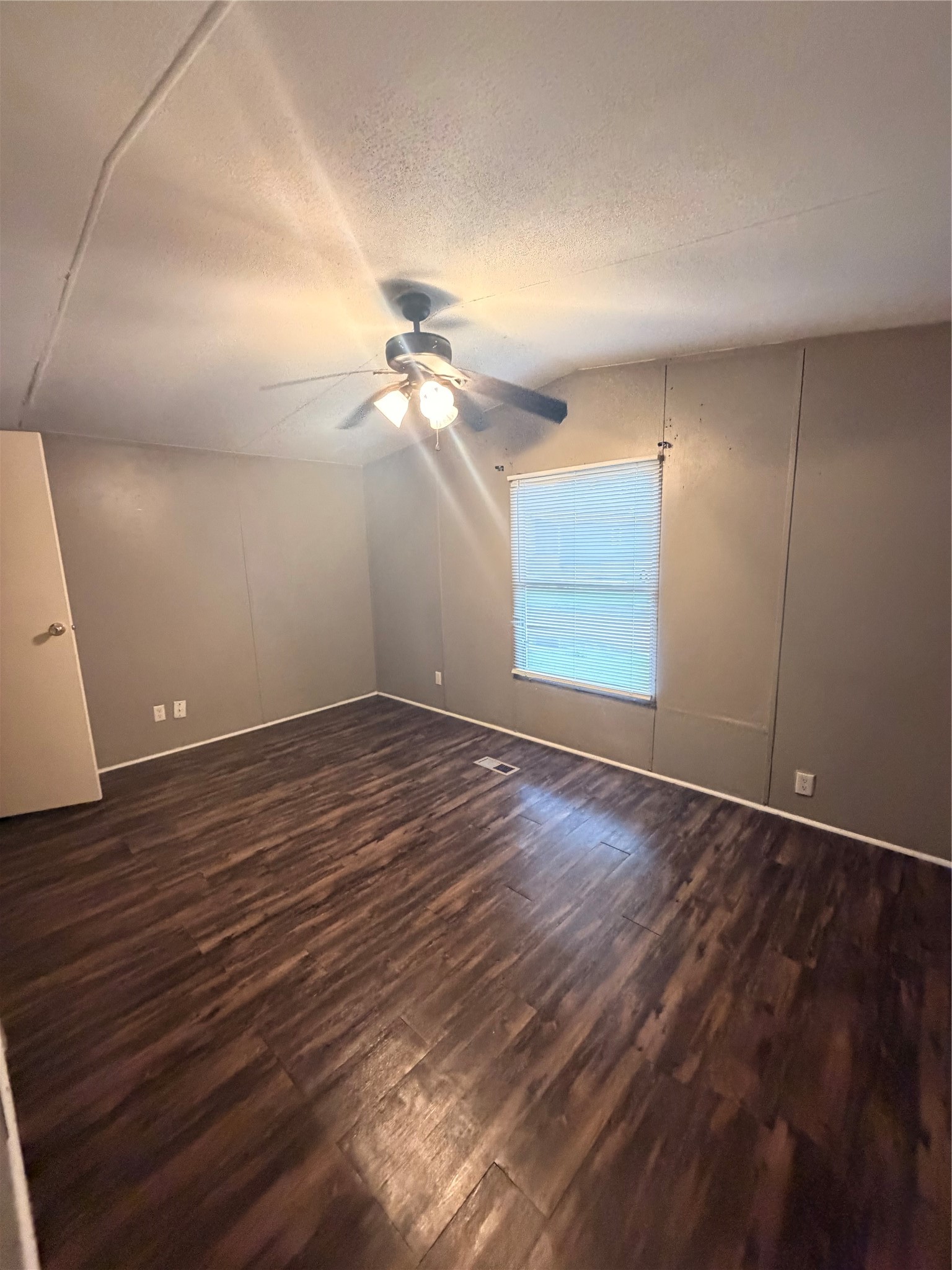 2021 North Battlebell Road, Unit 40 Highlands, TX 77562 - Photo 9 of 19 an empty room with wooden floor and windows