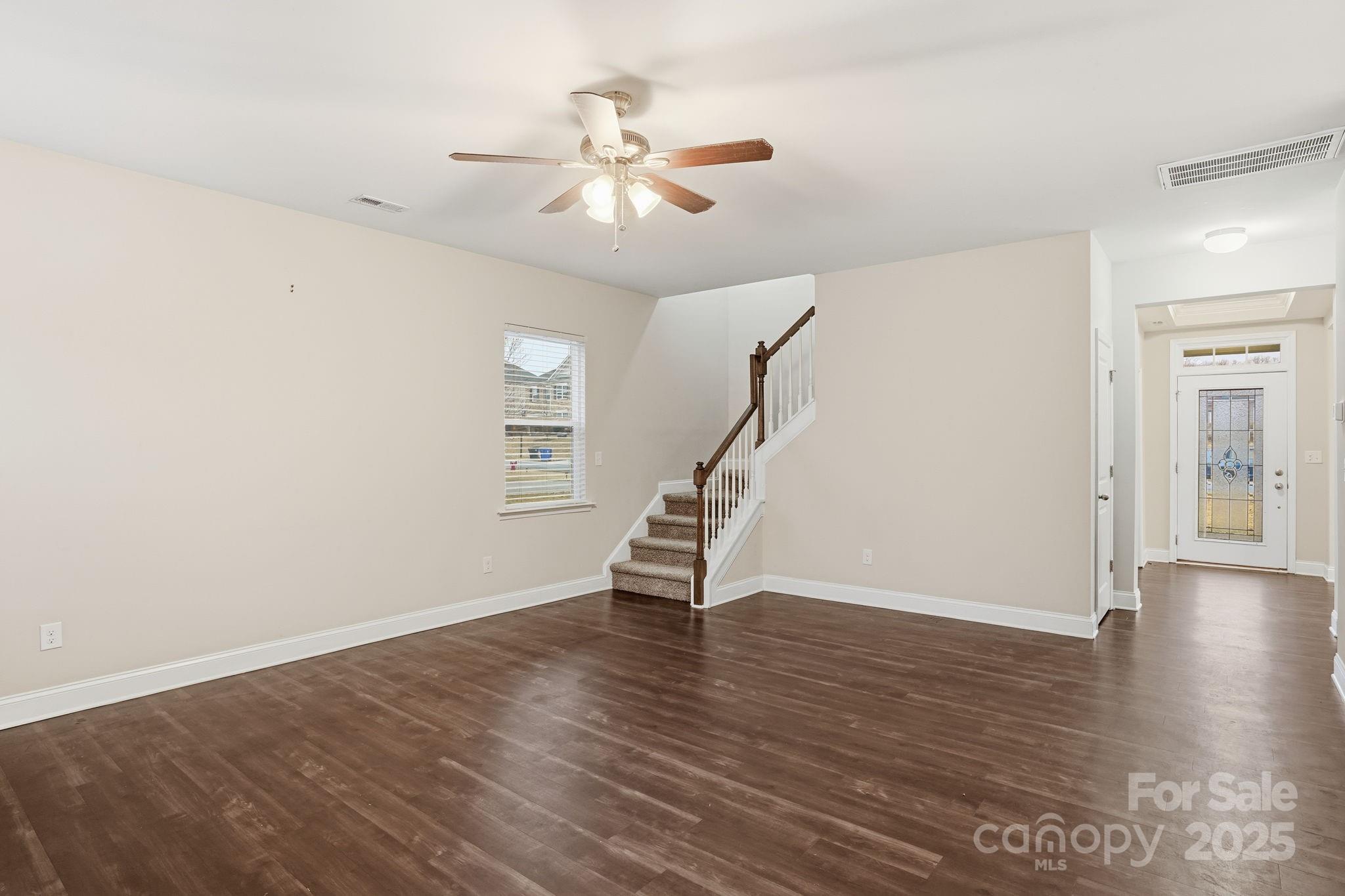 182 Sassafras Road Mooresville, NC 28115 - Photo 14 of 47 a view of an empty room with wooden floor and a ceiling fan