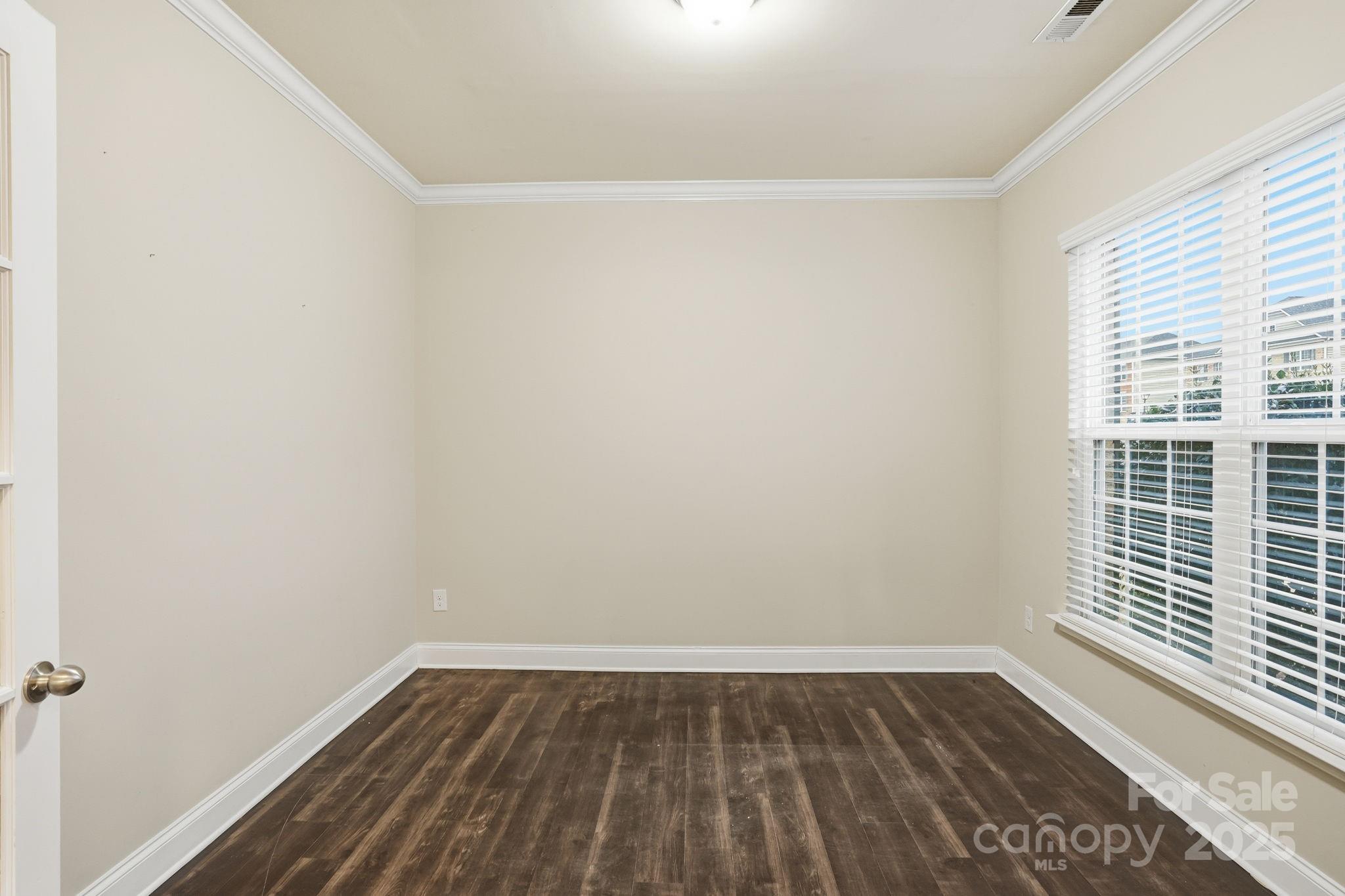 182 Sassafras Road Mooresville, NC 28115 - Photo 16 of 47 a view of an empty room with wooden floor and a window