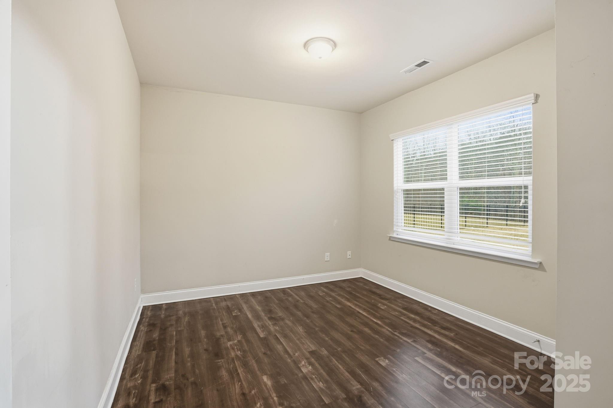182 Sassafras Road Mooresville, NC 28115 - Photo 20 of 47 an empty room with wooden floor and windows