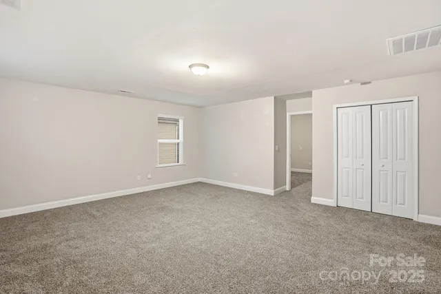 an empty room with closet area
