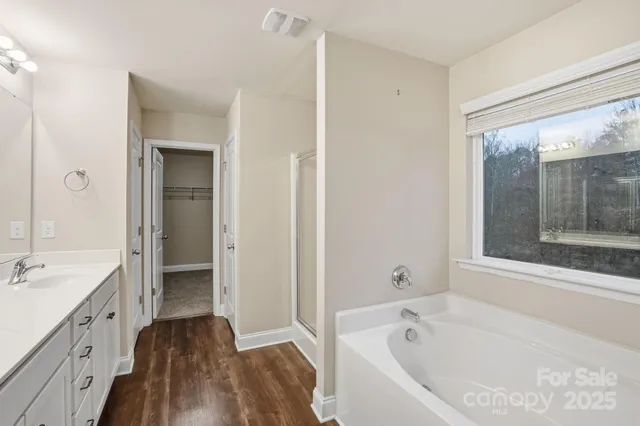 a bathroom with a bathtub shower and a sink