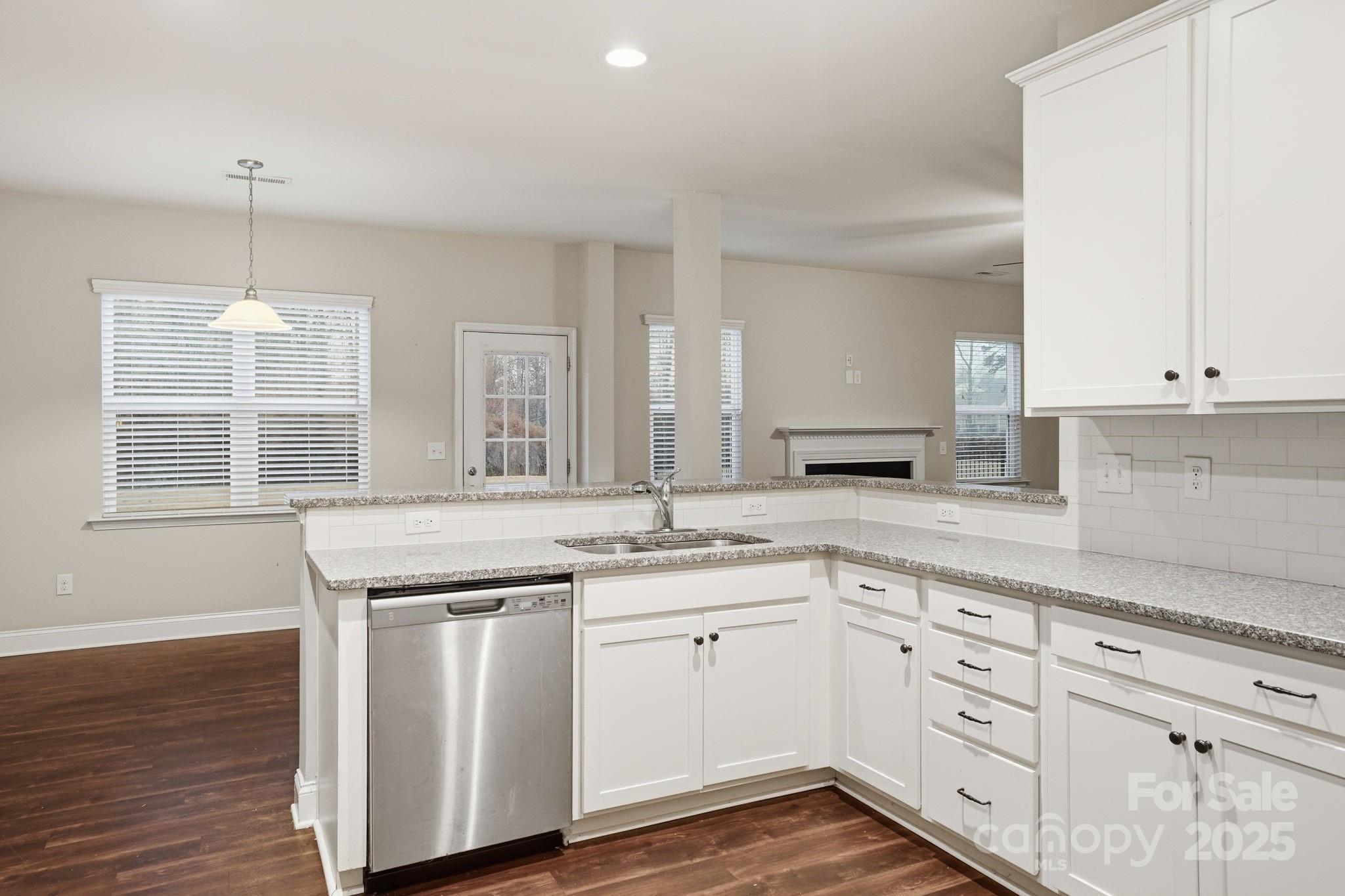 182 Sassafras Road Mooresville, NC 28115 - Photo 10 of 47 a kitchen with granite countertop white cabinets and white appliances