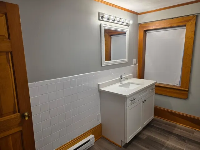a utility room with a sink a mirror and vanity